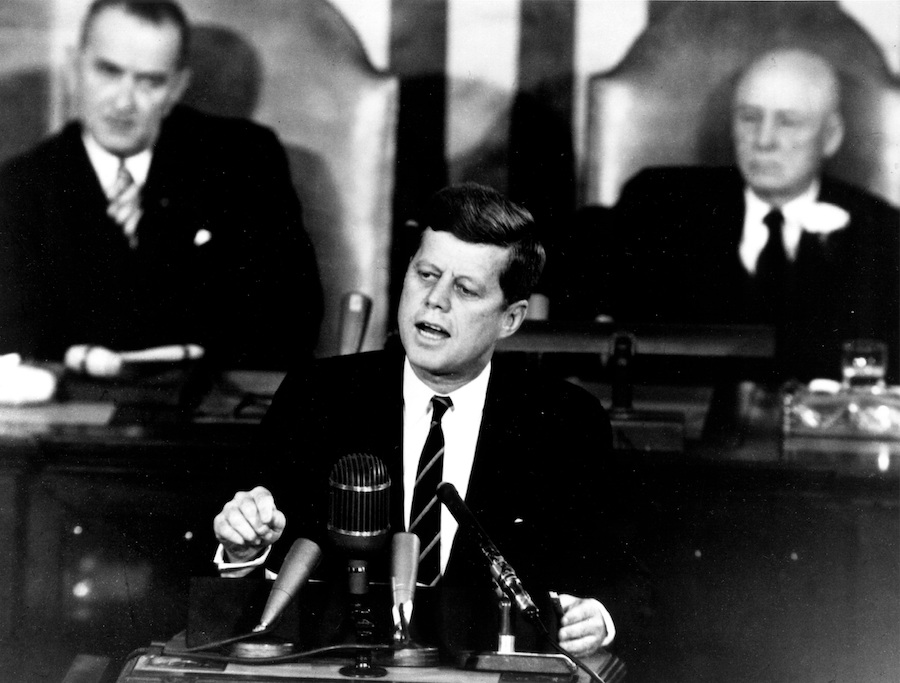 JFK speaking into a microphone