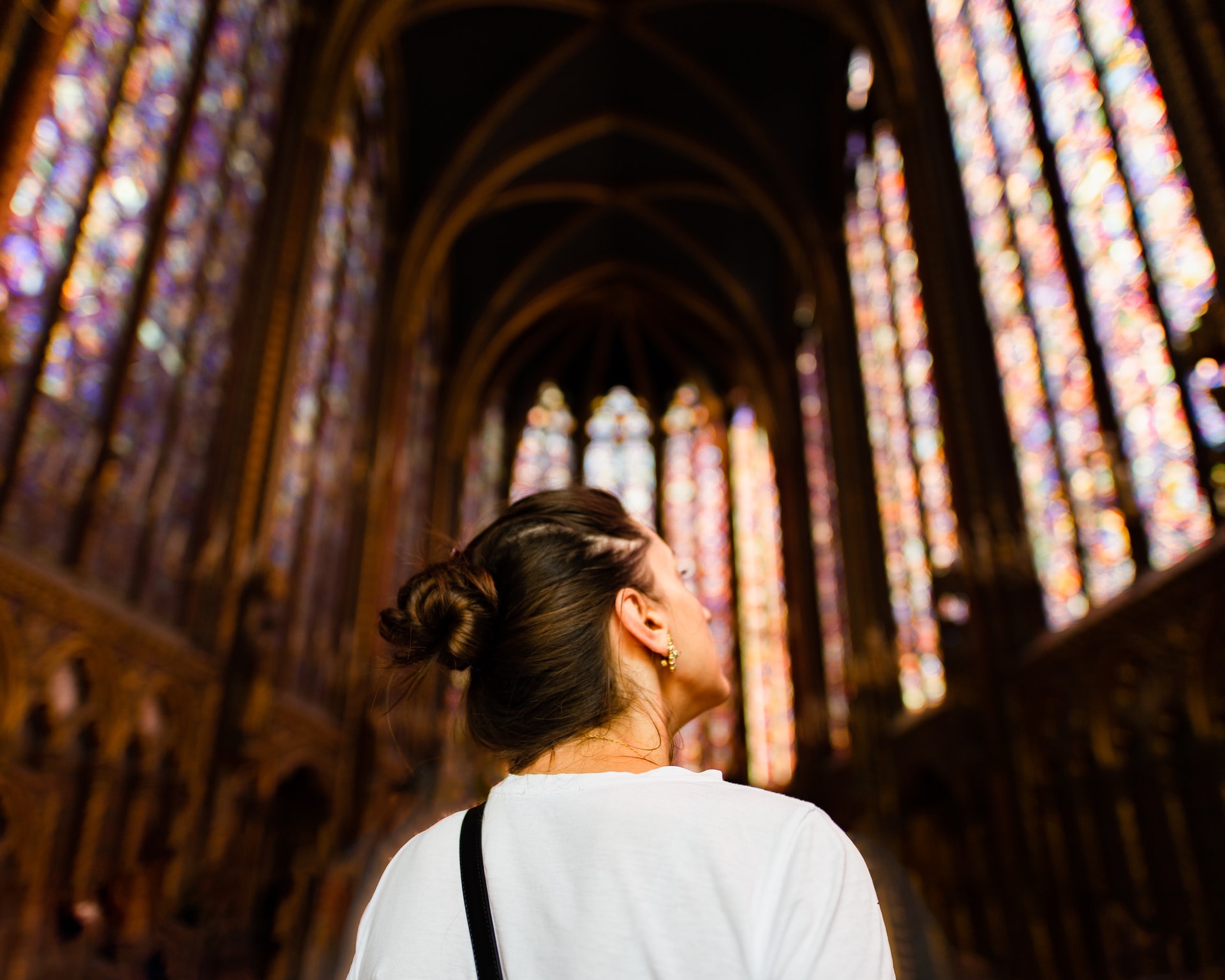Paris traveler looking at scenes depicted on the stained glass in Sainte-Chapelle