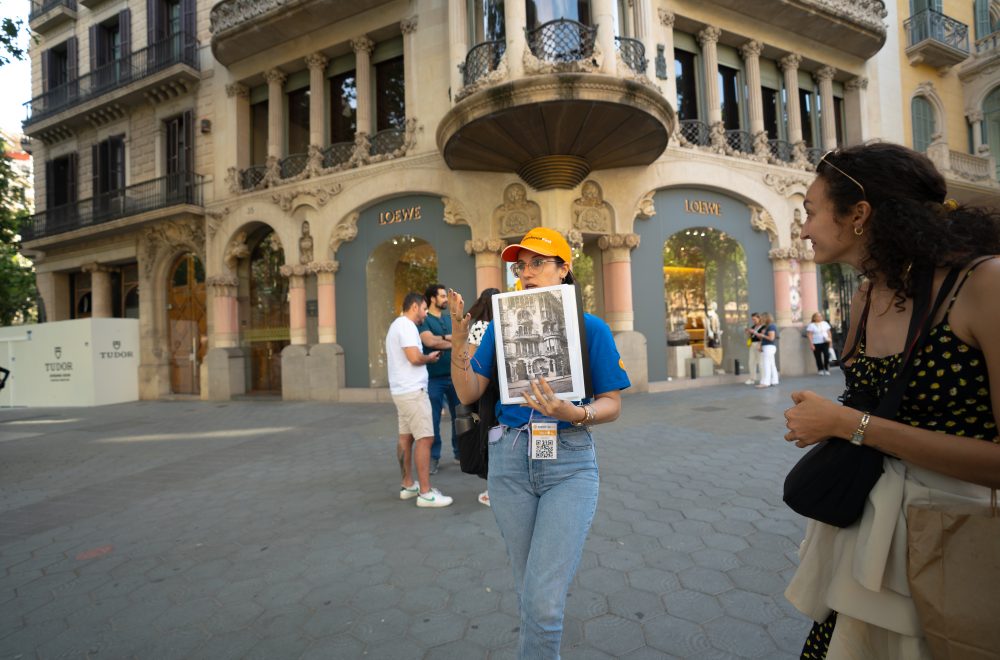 Tour guide explaining with references during Barcelona Architecture Tour