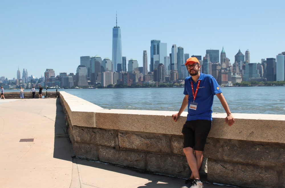 Tour Guide posing against New York Cityscape and Hudson river