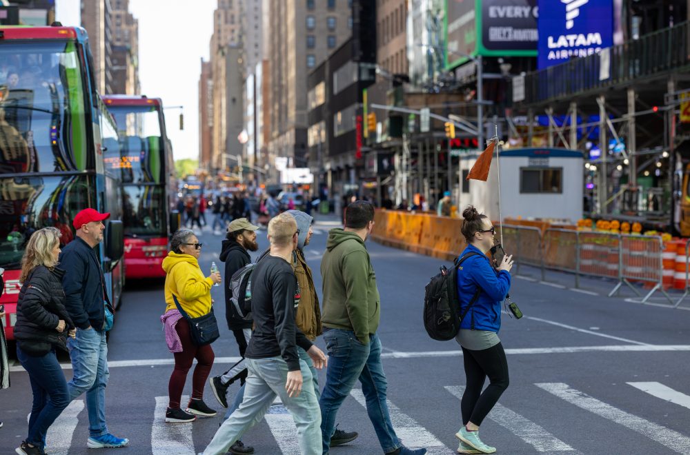 Tour group with guide crossing the road during NYC in a Day Tour