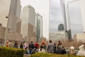 Tour guide and group with skyscrapers during 911 NYC tour