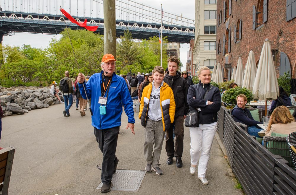 Group shot of guide and guests in Brooklyn, Bronx, Queens Bus Tour
