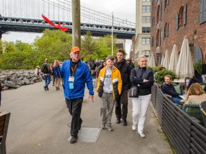 Group shot of guide and guests in Brooklyn, Bronx, Queens Bus Tour