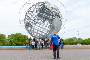 Group shot with guide taking the photo at Unisphere in Brooklyn, Bronx, Queens Tour