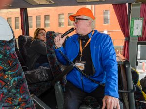 Tour Guide on Brooklyn, Bronx, Queens Bus Tour inside Bus