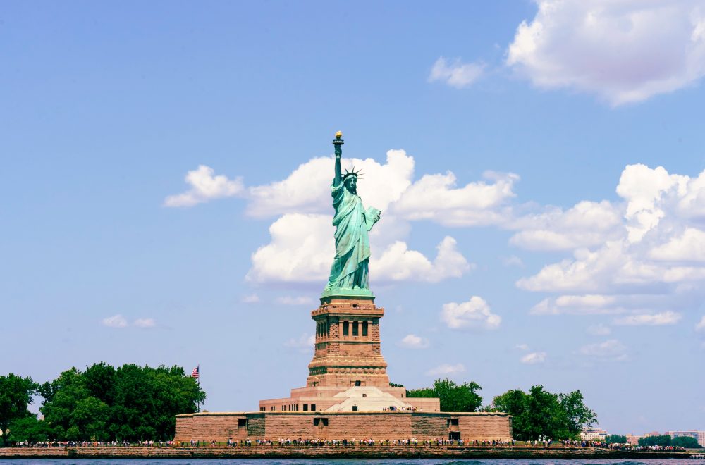 Tourists looking at Statue of Liberty from ferry