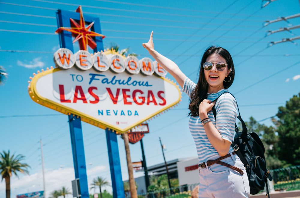 traveler pointing to the famous city sign