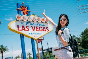 traveler pointing to the famous city sign