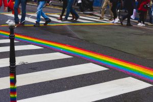 Pedestrian crosswalk with painted rainbow from both sides in Le Marais quarter in Paris