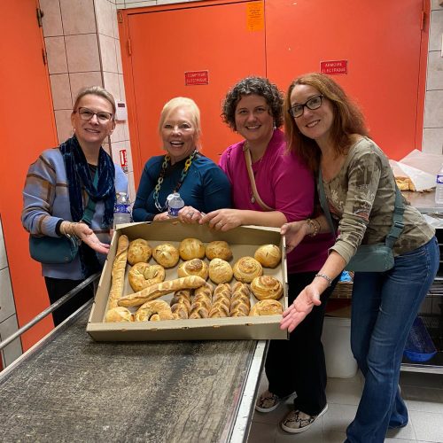 Guests posing with tray of freshly baked bread
