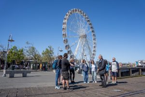 Group and tour guide near Ferris Wheel during Fisherman_s Wharf guided tour