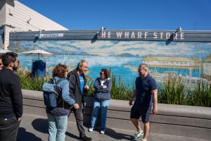 Tour guide and guests in front of the Wharf Store in San Francisco